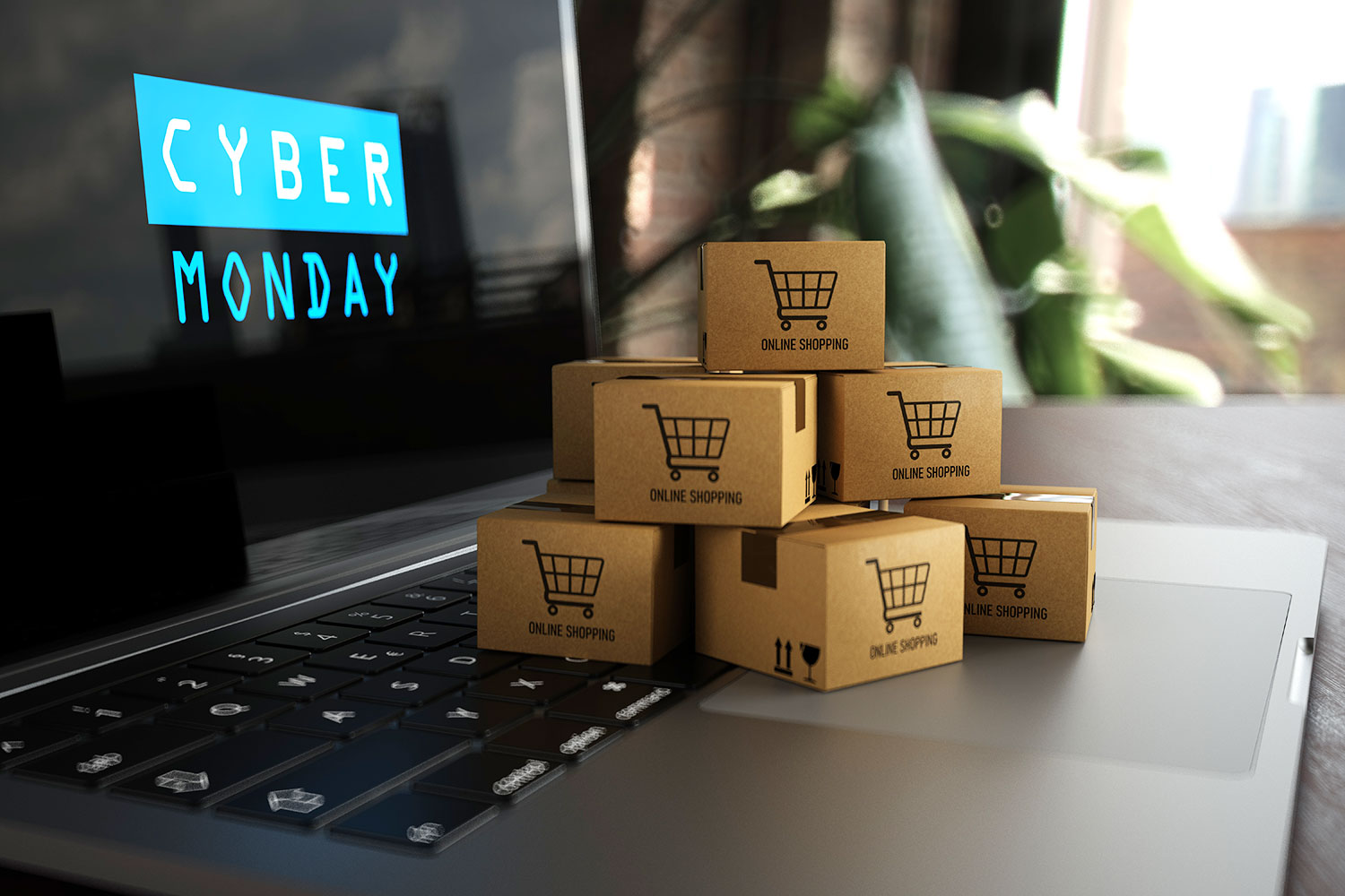 un ordenador portátil con el letrero de Cyber Monday en la pantalla y cajas de regalo sobre el teclado